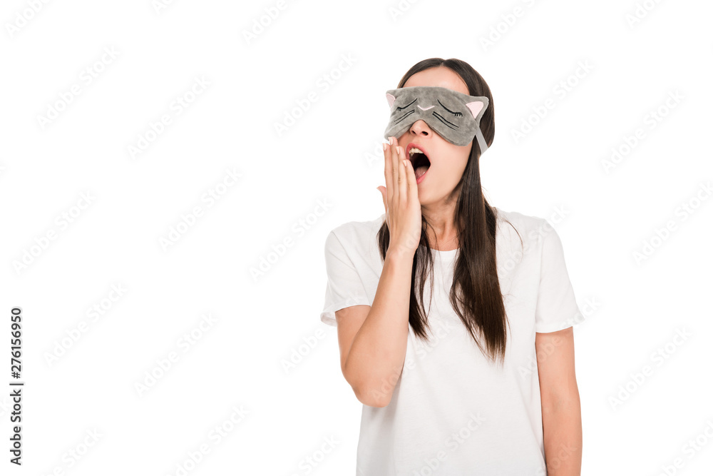 brunette young woman in cat sleeping eye mask yawning isolated on white