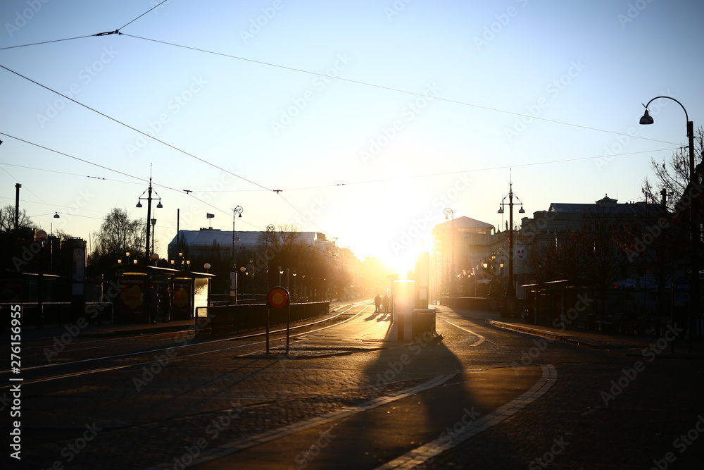 Early winter morning on a tram stop with strong sunlight on the Avenue, Gothenburg, Sweden
