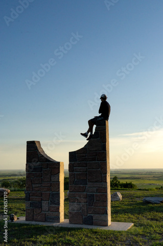Man atop a monolith viewing the vast plains of North Dakota from the Turtle Mountains Mystic Horizons