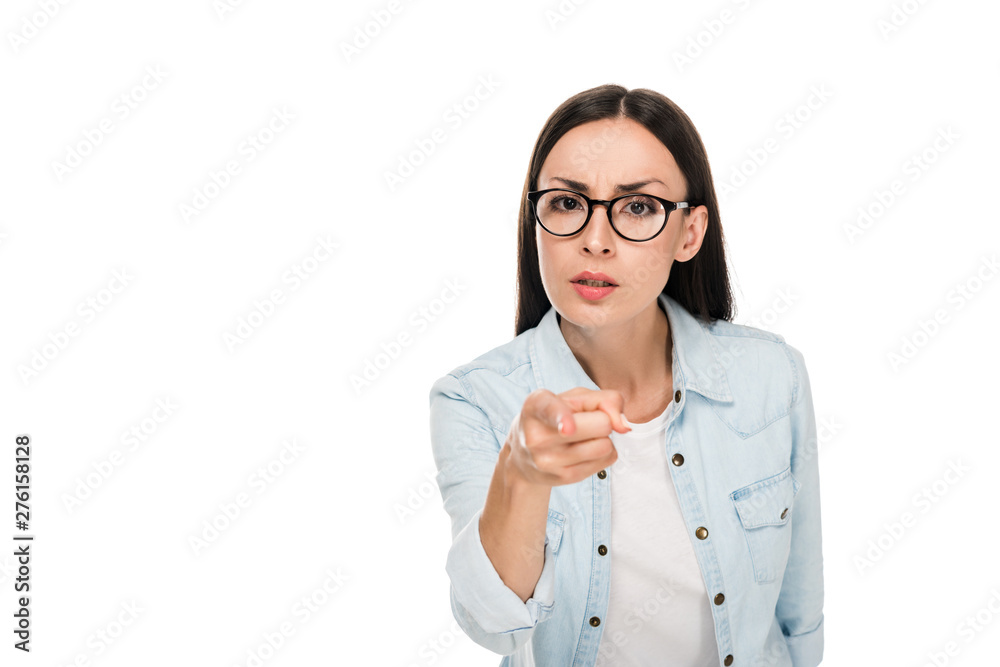angry brunette girl in glasses in denim jacket pointing with finger at camera isolated on white angry brunette girl in glasses in denim jacket pointing with finger at camera isolated on white
