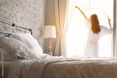 asian woman relaxing in the hotel room, strectching out, copy space