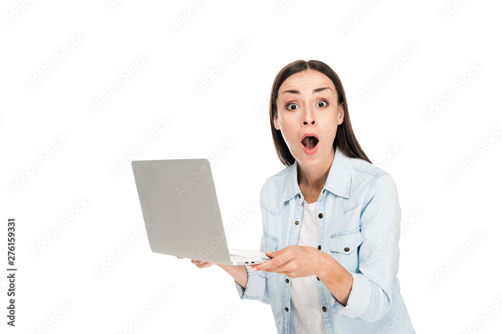shocked girl in denim jacket holding laptop isolated on white shocked girl in denim jacket holding laptop isolated on white
