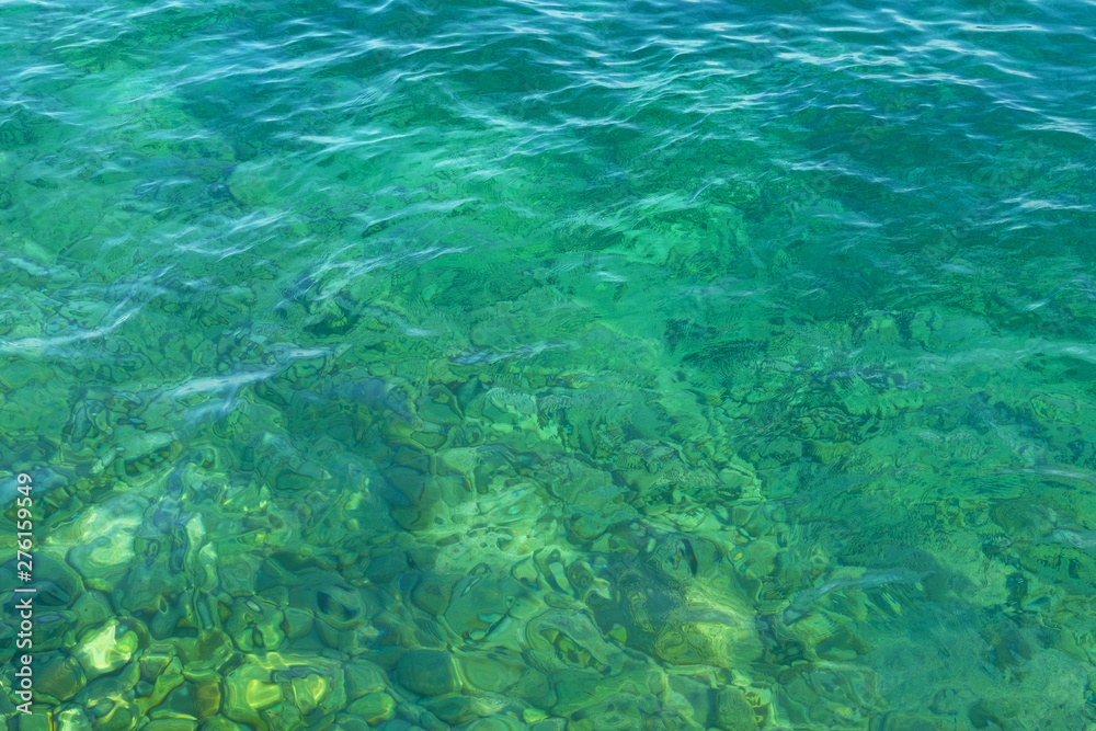 Green blue transparent sea water texture. Ocean water background. Summer vacation concept.