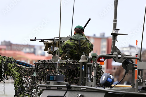 Swedish soldier with flags in naval base - Navy day showing combat boats, automatic guns, UAV, drone, warships, handguns, dive boat etc