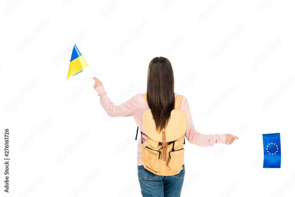 back view of student with backpack holding Ukrainian and European flags isolated on white back view of student with backpack holding Ukrainian and European flags isolated on white