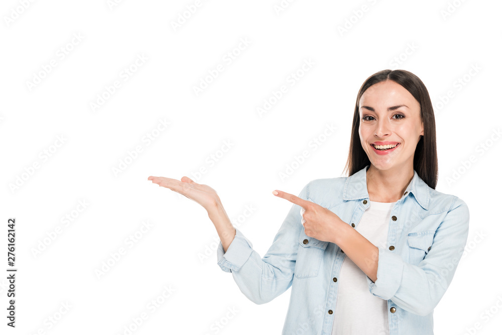 smiling happy brunette woman pointing with finger aside isolated on white smiling happy brunette woman pointing with finger aside isolated on white