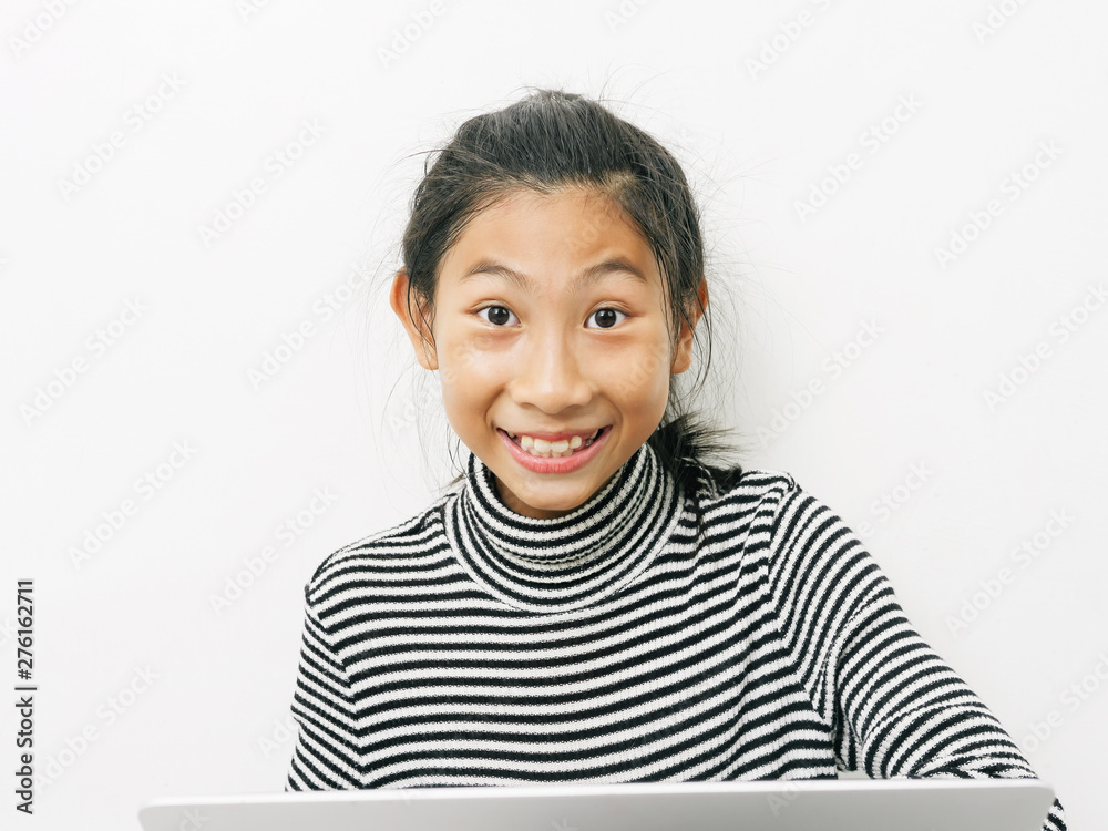 Asian girl sitting on floor and using laptop at home.