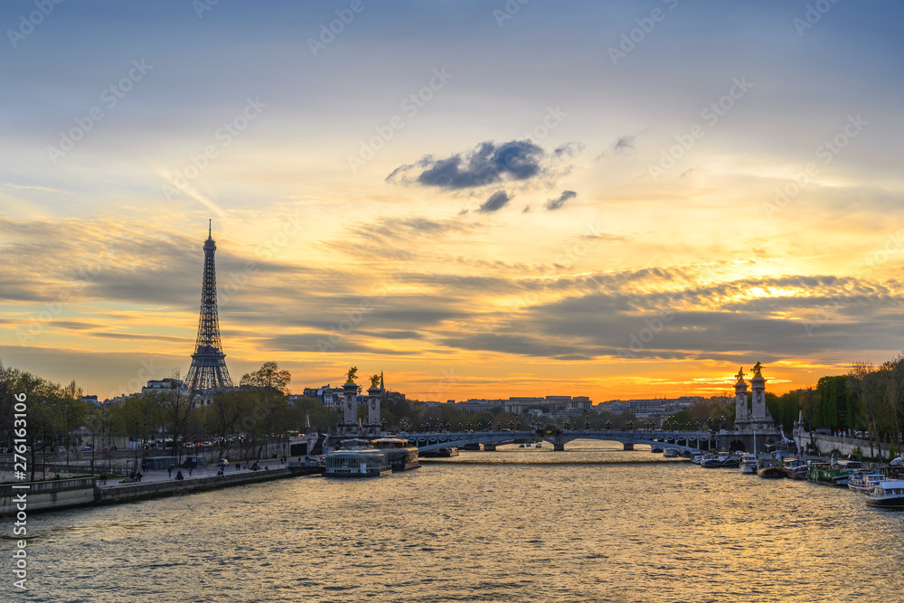Paris France city skyline sunset at Seine River with Pont Alexandre III bridge and Eiffel Tower
