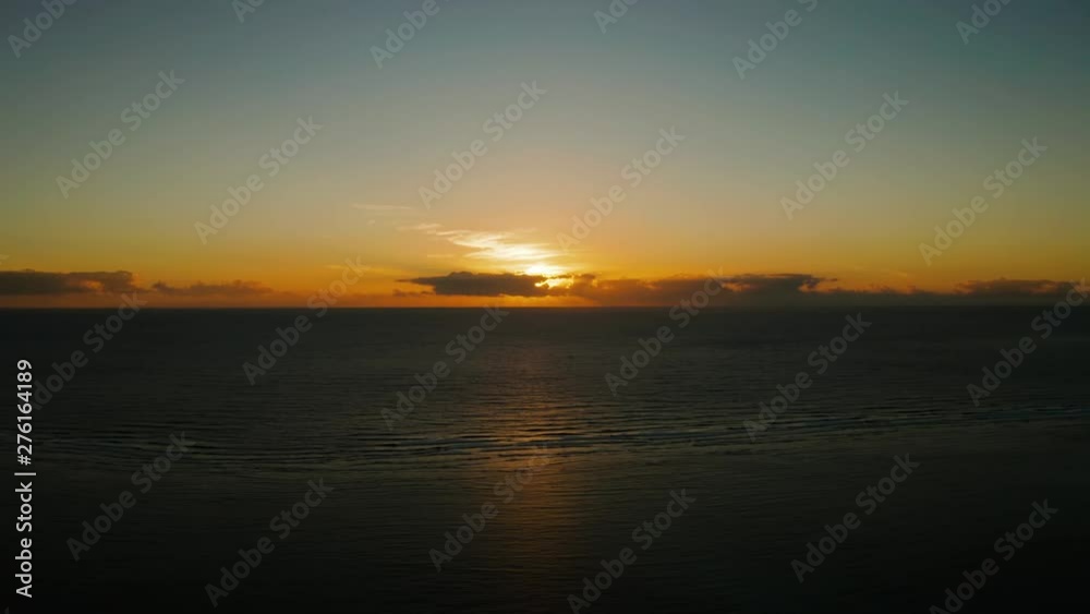 Morning sky with clouds during sunrise. Sunrise above the sea surface with waves, aerial view.Philippines. Sunrise over ocean. Morning sky with clouds during sunrise. Sunrise above the sea surface with waves, aerial view.Philippines. Sunrise over ocean.