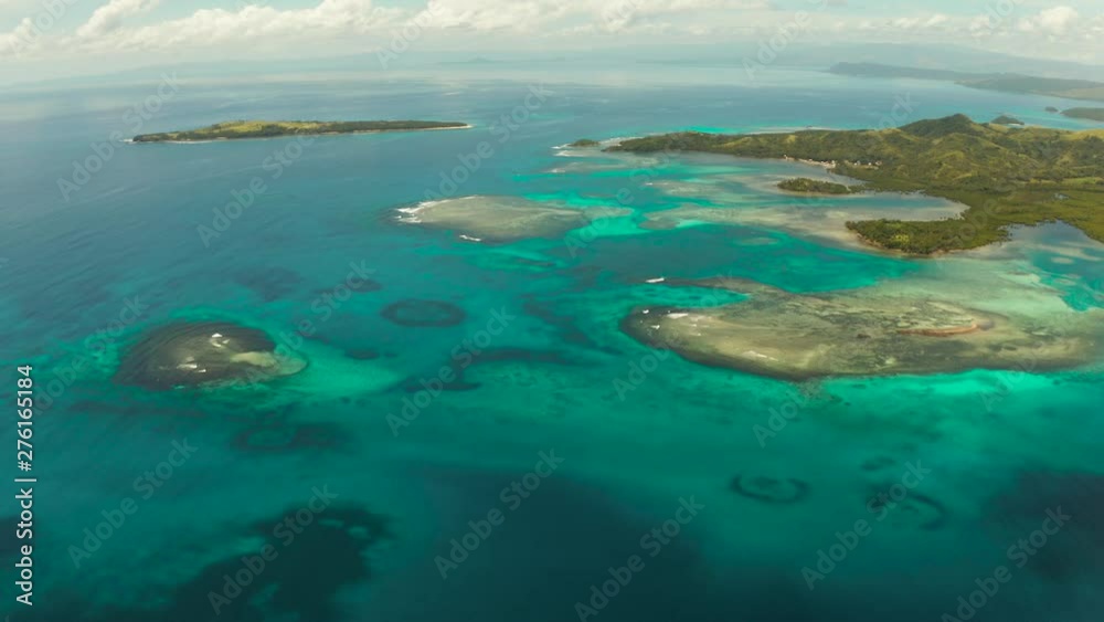 Tropical landscape: islands and atolls with blue water against the sky and clouds. Bucas grande, Philippines. Summer and travel vacation concept. Tropical landscape: islands and atolls with blue water against the sky and clouds. Bucas grande, Philippines. Summer and travel vacation concept.