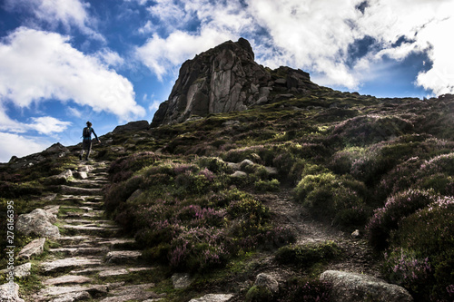 Tourist walks on the top of Clachnaben Hill. Glen Dye, Aberdeenshire, Scotland, UK photo