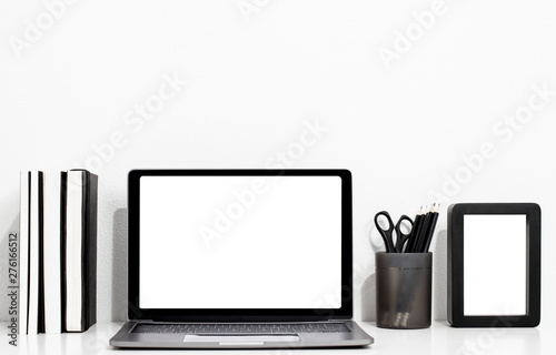 Digital technology Laptop with blank screen and book,picture frame on white table of wood ,Home interior or office background