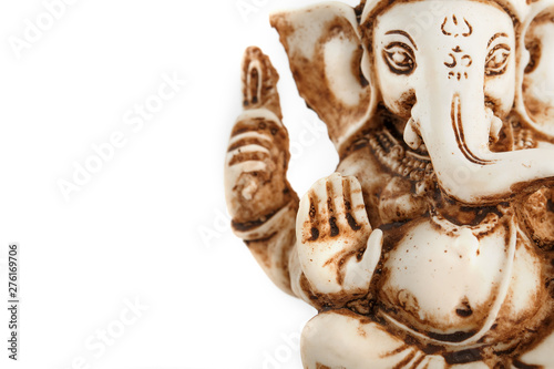 Hindu god Ganesh on a black background. Statue with incense smoke aromo sticks