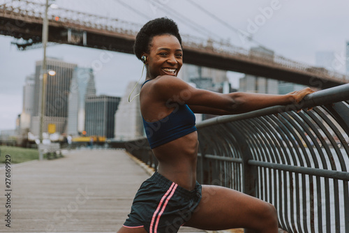 Athlete woman training in the morning at sunrise in New york city  Brooklyn in the background