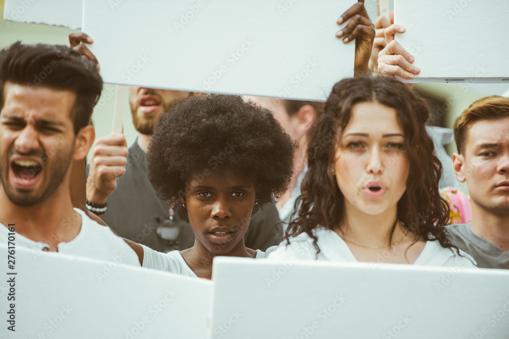 Public demonstration on the street against social problems and human rights. Group of multiethnic people making public protest - obrazy, fototapety, plakaty 