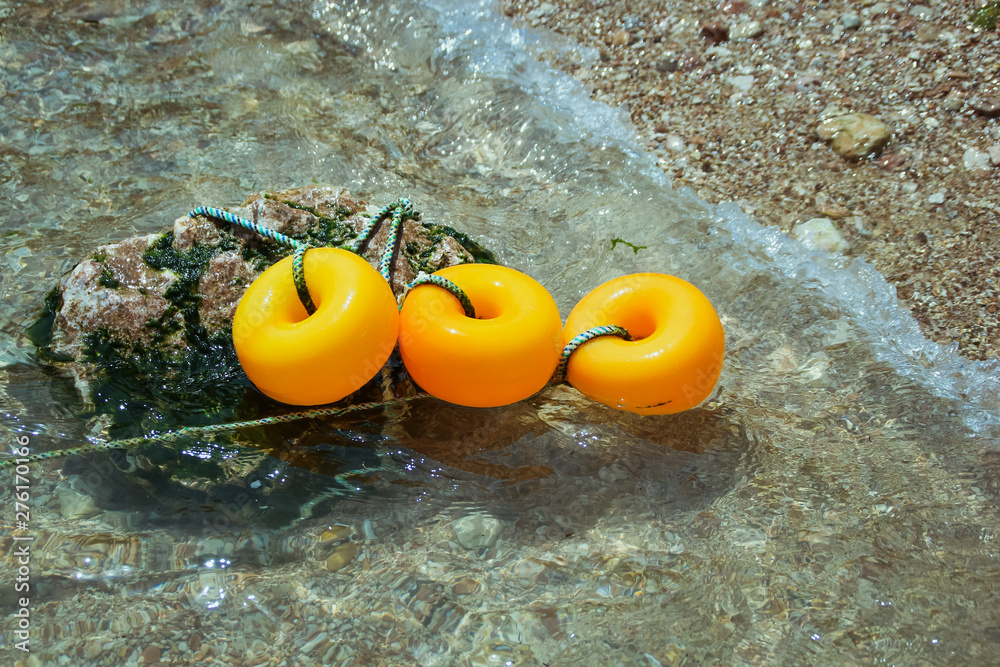 Naklejka premium Orange buoy gray Keep available safety float marker