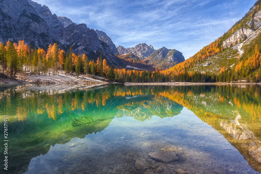 Gorgeous and chic colourful autumn view of Lago di Braies in Dolomites mountains forest.  Amazing autumn forest is reflected in the emerald surface of the water. South Tyrol. Dolomite, Italy, Europe. 