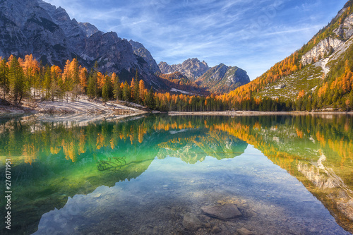 Fototapeta Naklejka Na Ścianę i Meble -  Gorgeous and chic colourful autumn view of Lago di Braies in Dolomites mountains forest.  Amazing autumn forest is reflected in the emerald surface of the water. South Tyrol. Dolomite, Italy, Europe. 