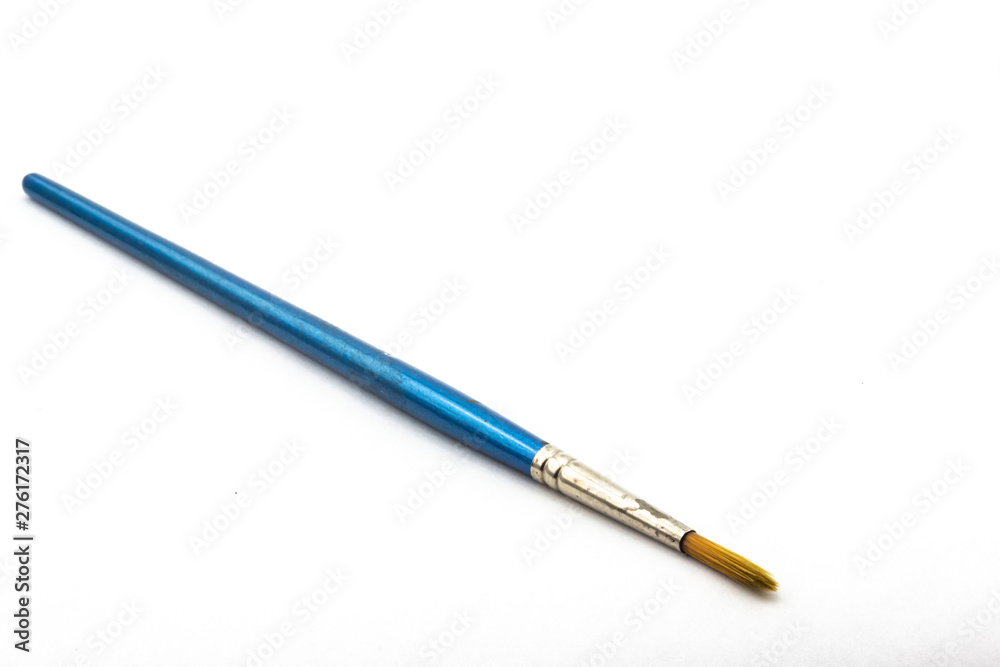 Old used watercolor paintbrush on white background Old used watercolor paintbrush on white background