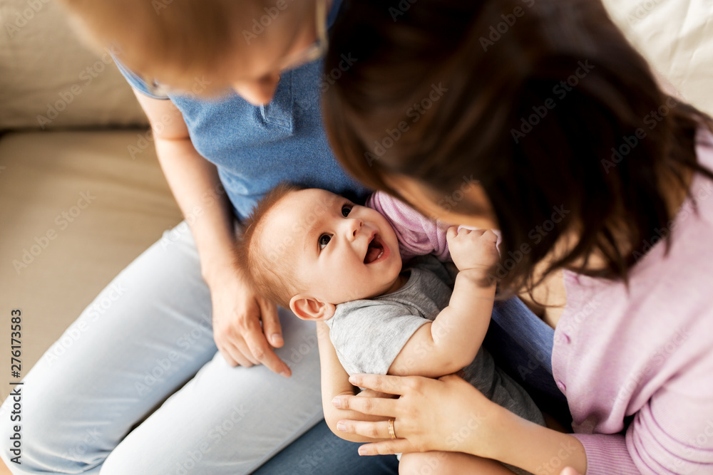 mixed-race family, parenthood and people concept - happy mother and father with baby son at home - obrazy, fototapety, plakaty 