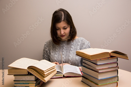 Student girl with stack of books 