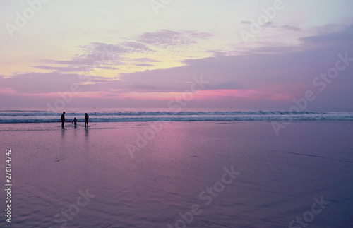 Young family with child on the beach at sunset time © badahos