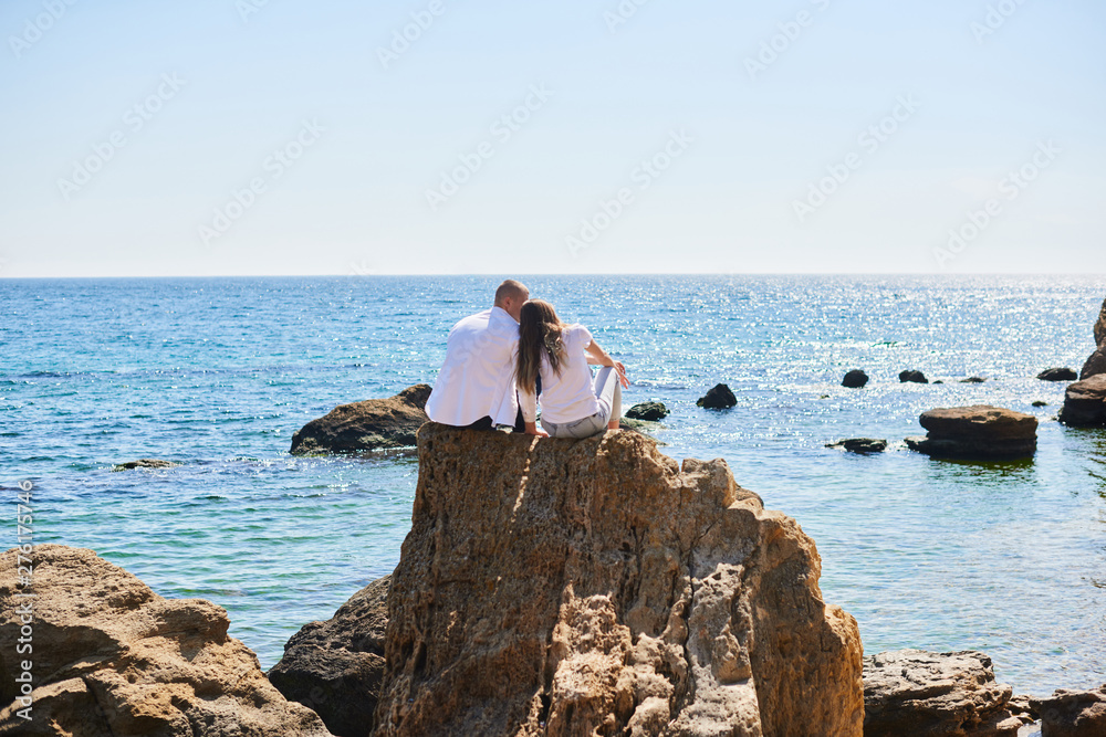 couple in love travels around islands and mountains. Couple in love hugging on a tropical beach with a turquoise water couple in love travels around islands and mountains. Couple in love hugging on a tropical beach with a turquoise water