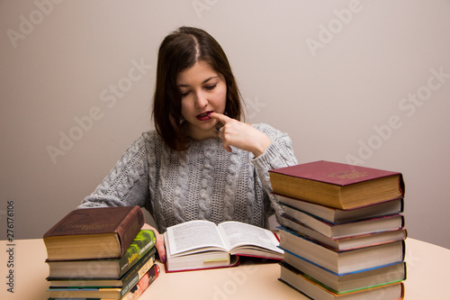 Student girl with stack of books 