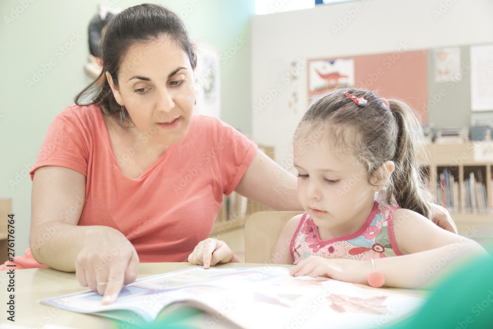 Woman teacher in a extra tutoring class with a child girl using. Empty copy space for Editor's text. Woman teacher in a extra tutoring class with a child girl using. Empty copy space for Editor's text.