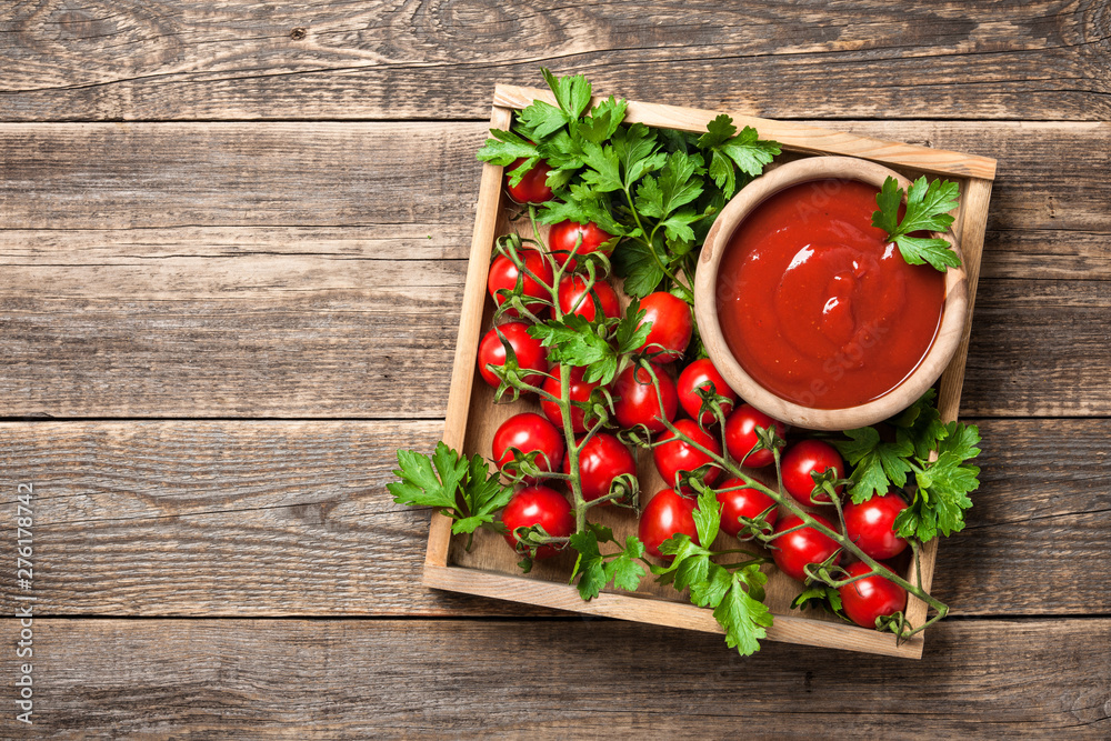 Tomato sauce, fresh tomatoes and parsley on wooden table Tomato sauce, fresh tomatoes and parsley on wooden table