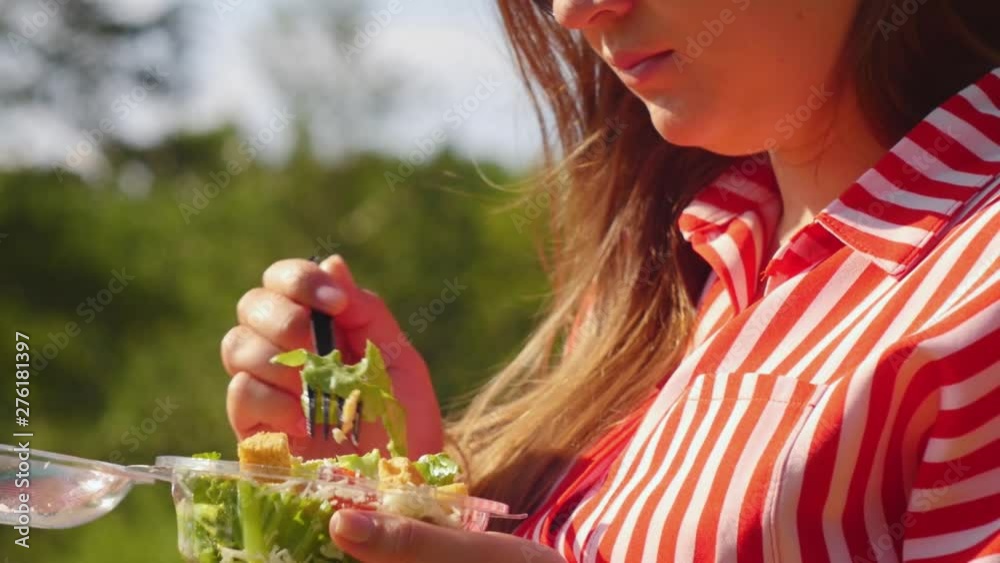 Pregnant woman keep in hands salad and eat with fork stirring. Healthy eating. Close up shot. Pregnant woman keep in hands salad and eat with fork stirring. Healthy eating. Close up shot.