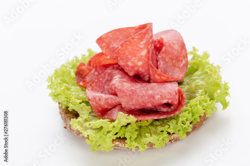 Sandwich with salami sausage on white background.