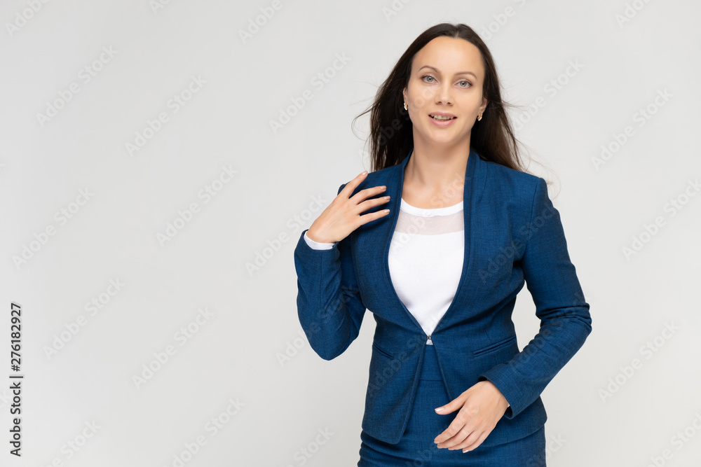 Portrait of a young pretty brunette woman manager 30 years in a business blue suit with beautiful dark hair. on a white background, talking, showing hands, demonstrating emotions. Portrait of a young pretty brunette woman manager 30 years in a business blue suit with beautiful dark hair. on a white background, talking, showing hands, demonstrating emotions.