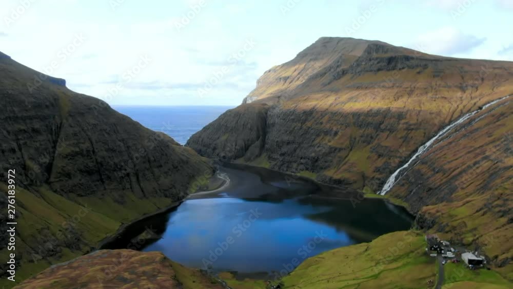Aerial Lake Between Rocky Hills, Scattered Buildings in Foreground of Valley, Streymoy Island, Faroe Islands