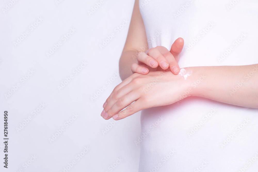The girl rubs the healing ointment into the wrist joint against pain