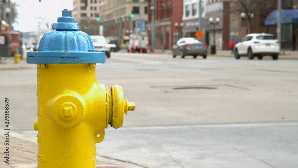 City fire hydrant with cars in background slow motion City fire hydrant with cars in background slow motion