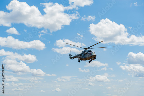 Flying military transport helicopter special for army soldier in fight war. Military soldier volant in transport helicopter above clean blue sky. Helicopter is military transport to army soldier