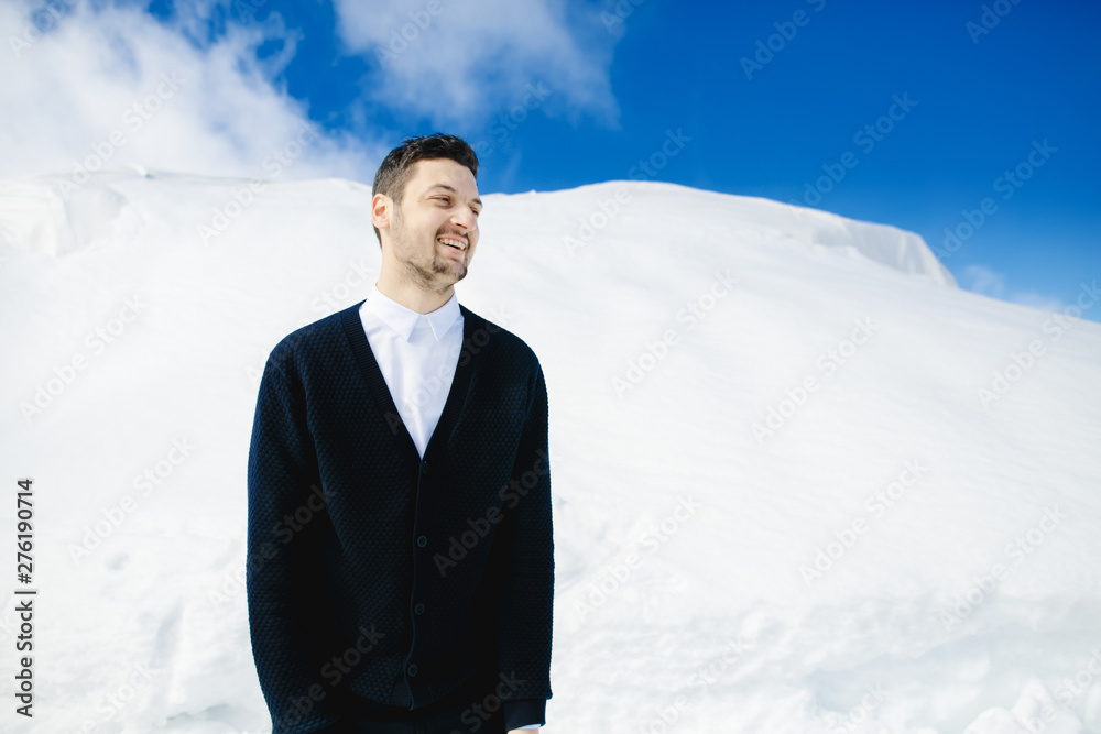 Man standing on the slope of snowy mountain Man standing on the slope of snowy mountain
