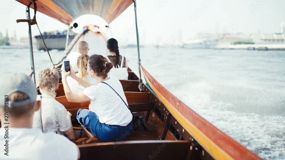 Speed Long-tail boat carriing a tourists by the Chao Phraya River - the main river of Bangkok, Thailand slow motion footage