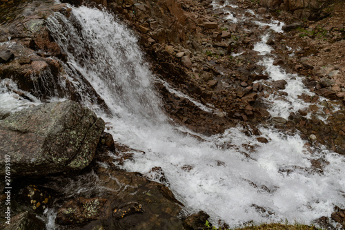 Stormy waters of the northern waterfall in a rocky gorge on the shores of the cold sea