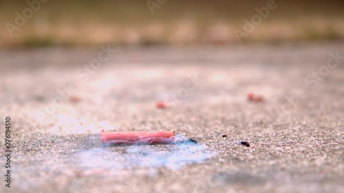 Single firecracker exploding on concrete ground slow motion photo