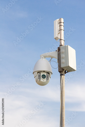 Security Camera on a blue sky background. Surveillance camera for guarding territory. Security of private property.