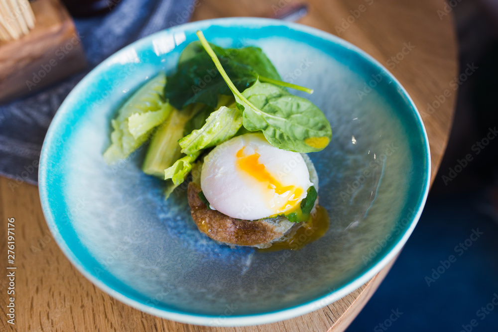 wholesome breakfast. Poached egg and avocado with greens wholesome breakfast. Poached egg and avocado with greens