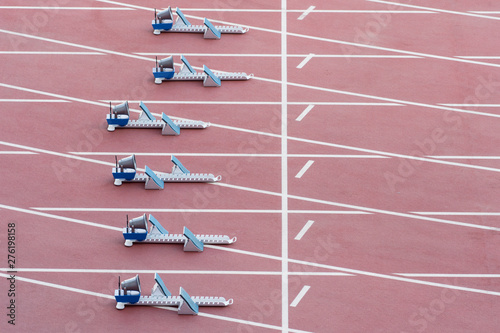 Athletic start block on dark red tartan track © Augustas Cetkauskas