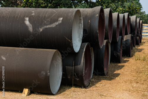 side view of ductile iron pipes stored in open space store yard.
