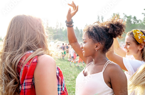 Group of friends having fun at summer music festival