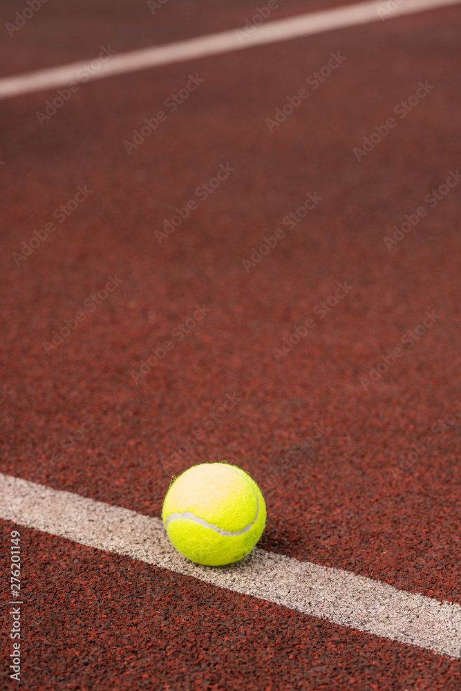 Single yellow ball for playing tennis on white line