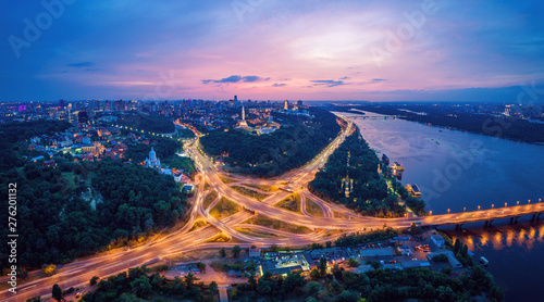 Night city panorama of the Kiev city with the Paton Bridge and the Dnieper River. Ukraine
