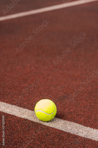Single yellow ball for playing tennis on white line © pressmaster