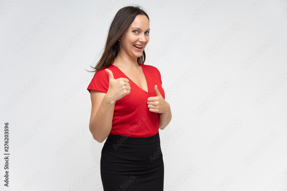 Portrait to the waist of a young pretty brunette woman of 30 years old in a bright red sweater with beautiful dark hair. Standing on a white background, talking, showing hands, with emotions Portrait to the waist of a young pretty brunette woman of 30 years old in a bright red sweater with beautiful dark hair. Standing on a white background, talking, showing hands, with emotions